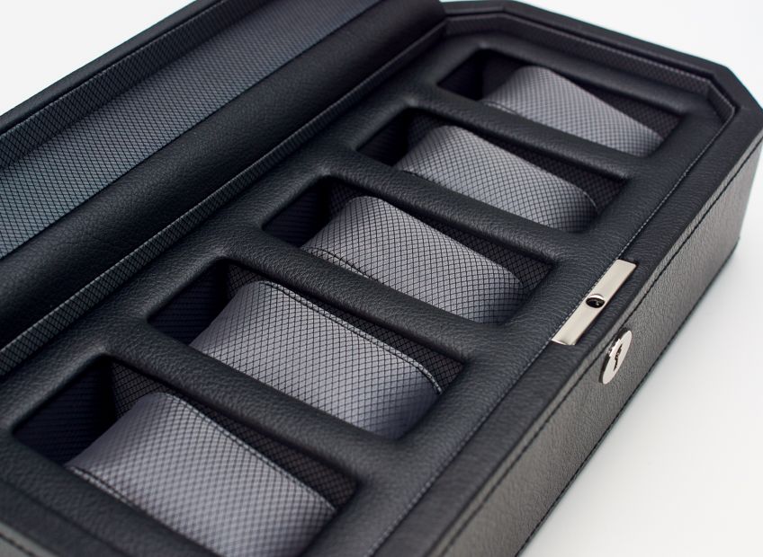 Black watch box with five padded compartments and silver clasp closure.