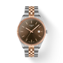 Tissot watch with rose gold and silver band on white background