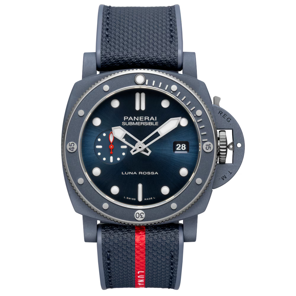 The Panerai Submersible QuarantaQuattro Luna Rossa Ti-Ceramitech™ features a navy blue dial, textured strap with red stripe, luminescent markers, date display, and a robust diver’s casing.