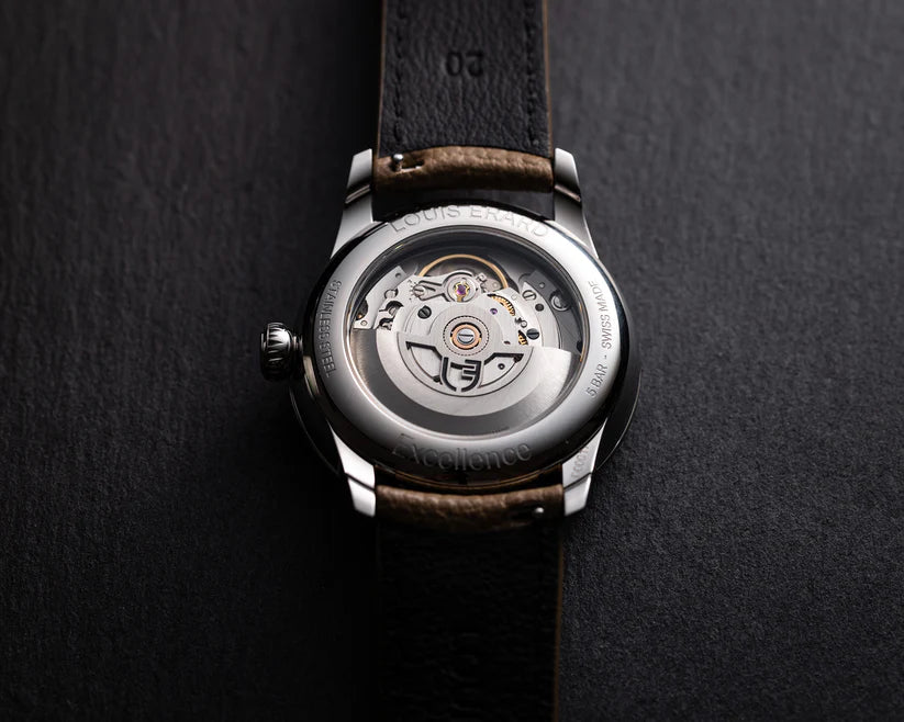 Watch with visible mechanical components on a dark background
