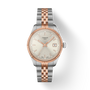 Tissot watch with two-tone rose gold and silver bracelet on a white background