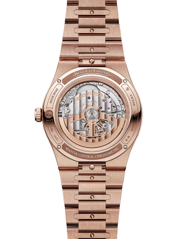 Rose gold men's watch with visible mechanical movement through caseback, linked bracelet, and engraved bezel.