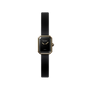 The Chanel Première Ribbon is a minimalist wristwatch with a slim black leather strap and a small octagonal black-lacquered dial edged in yellow gold, featuring gold hands, the Chanel logo, and "SWISS" in white.