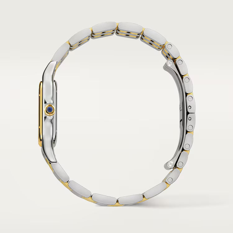 Silver and gold watch band on a light gray background