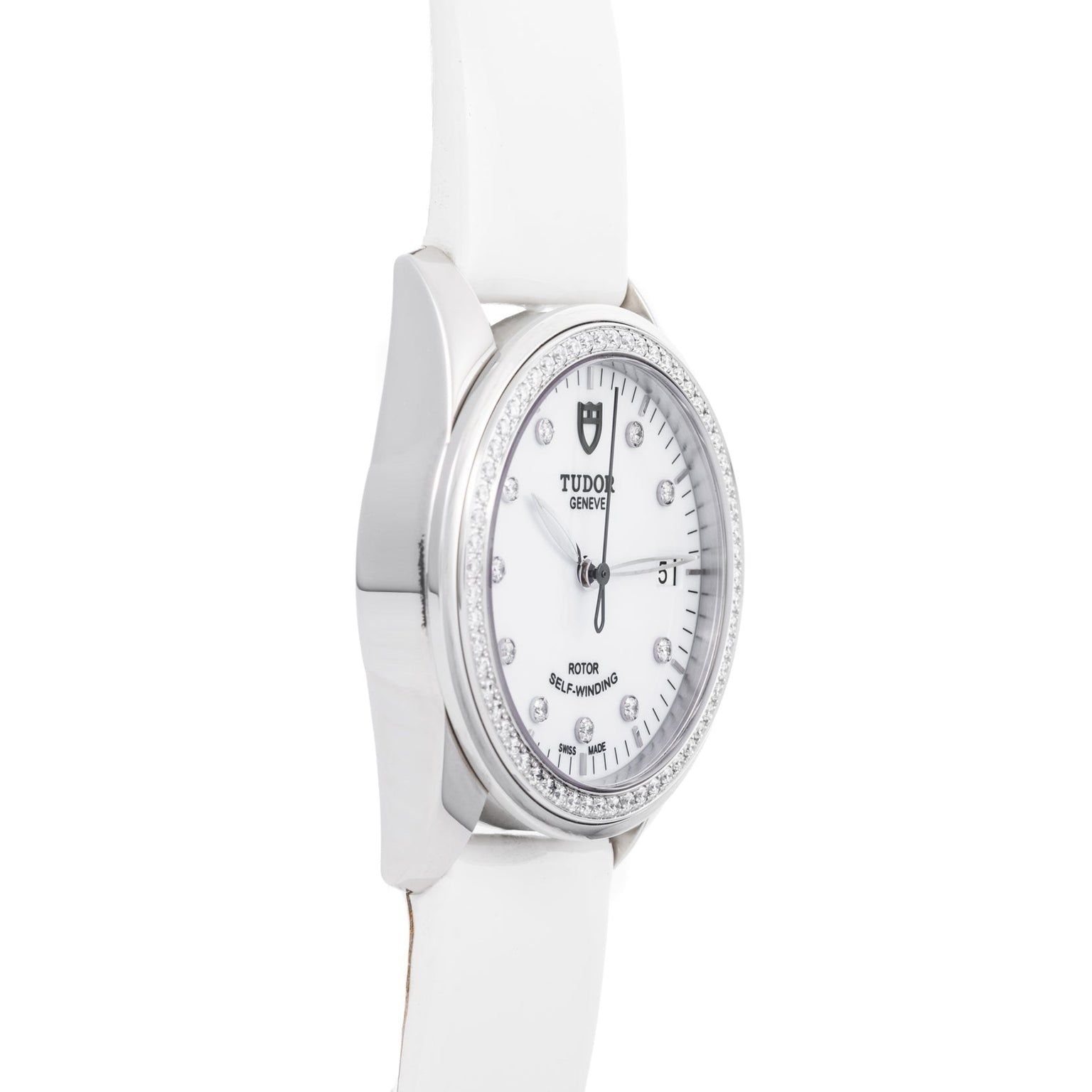 The TUDOR Glamour Date is a white wristwatch featuring a round face, diamond hour markers, and a white leather strap.