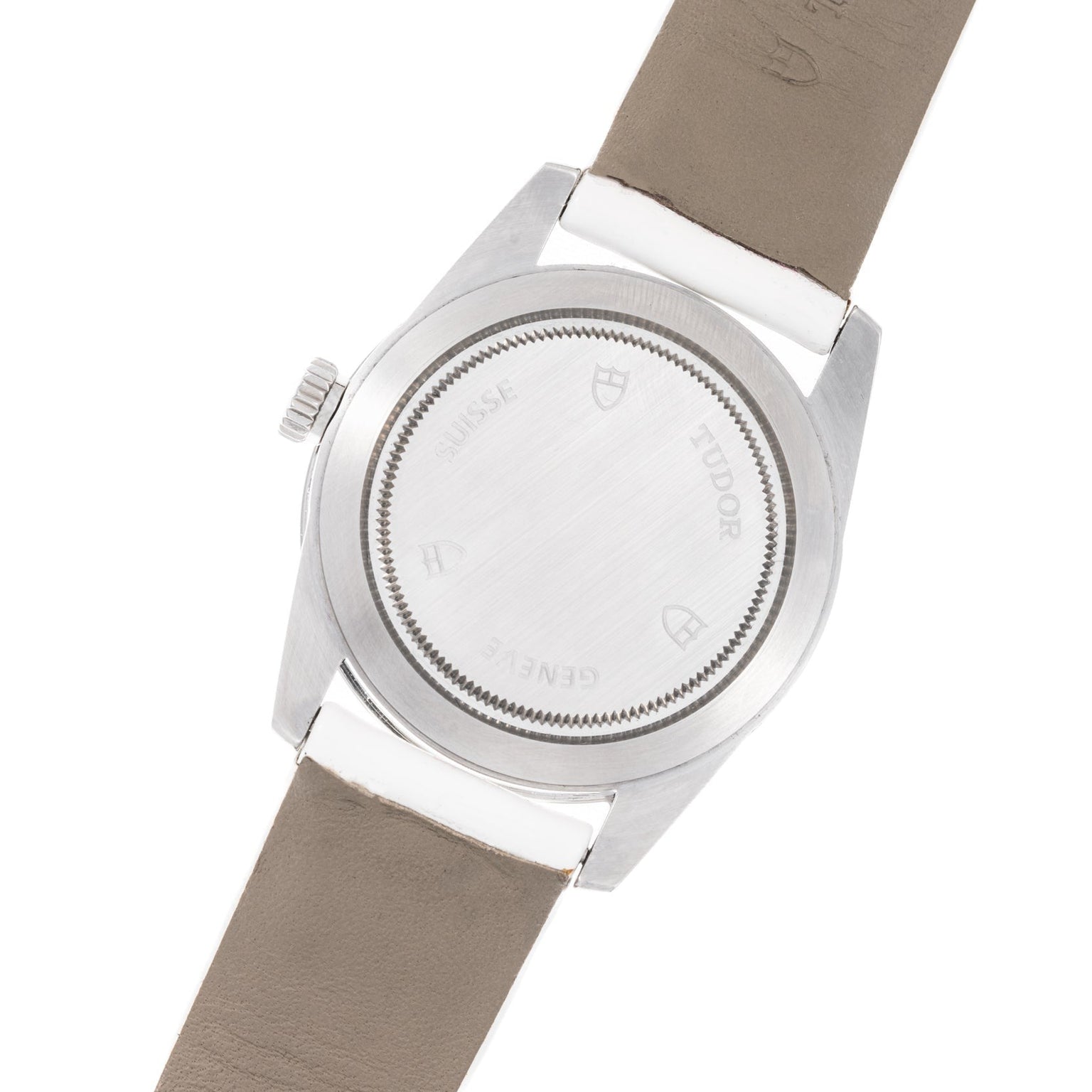 Back view of the TUDOR Glamour Date wristwatch featuring a silver case, taupe leather strap, and engraved markings.