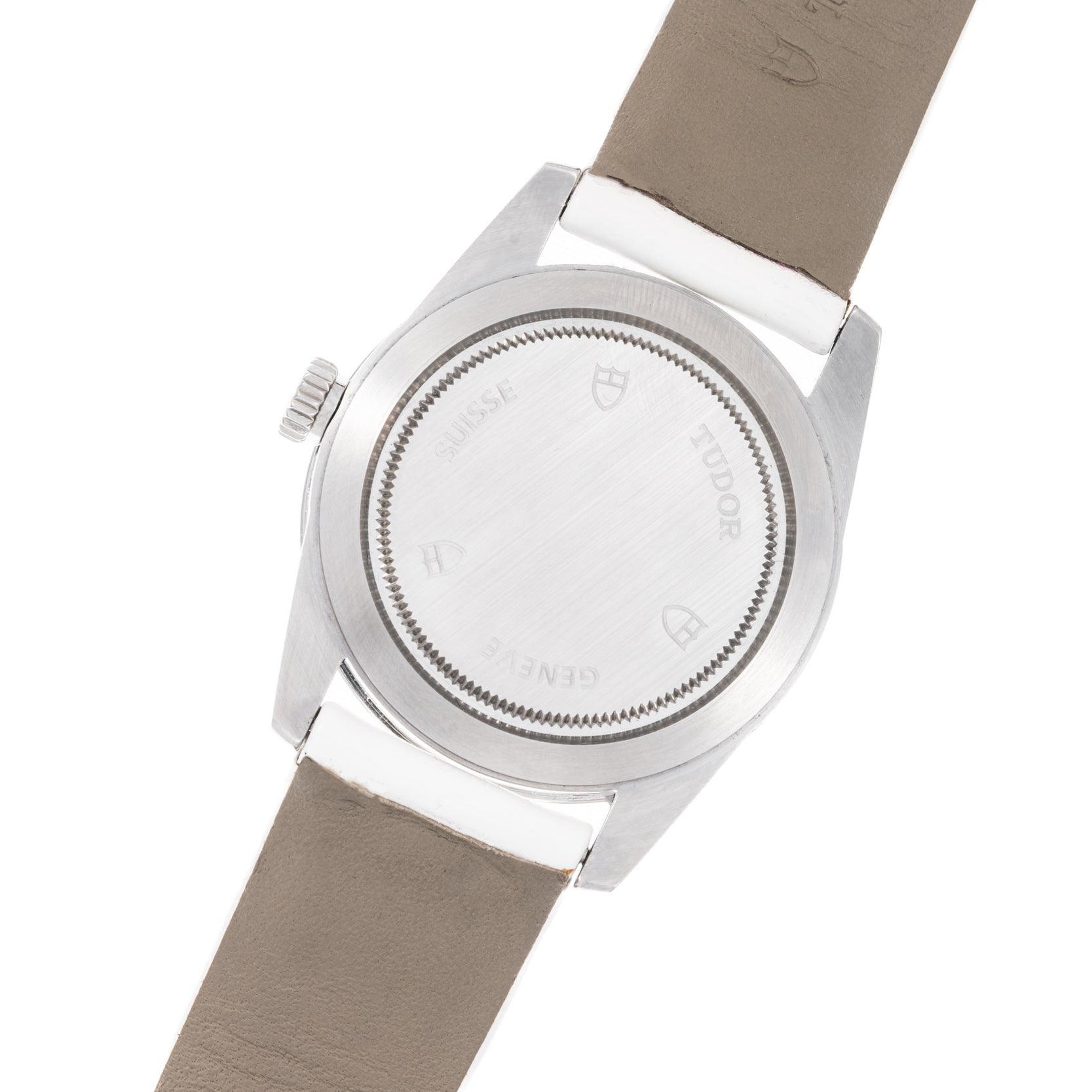 Back view of the TUDOR Glamour Date wristwatch featuring a silver case, taupe leather strap, and engraved markings.