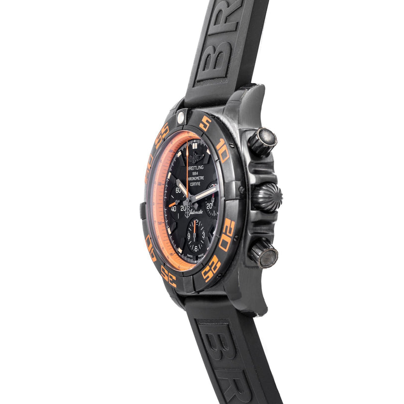Side view of the Breitling Chronomat Raven wristwatch featuring orange accents and a black rubber strap.