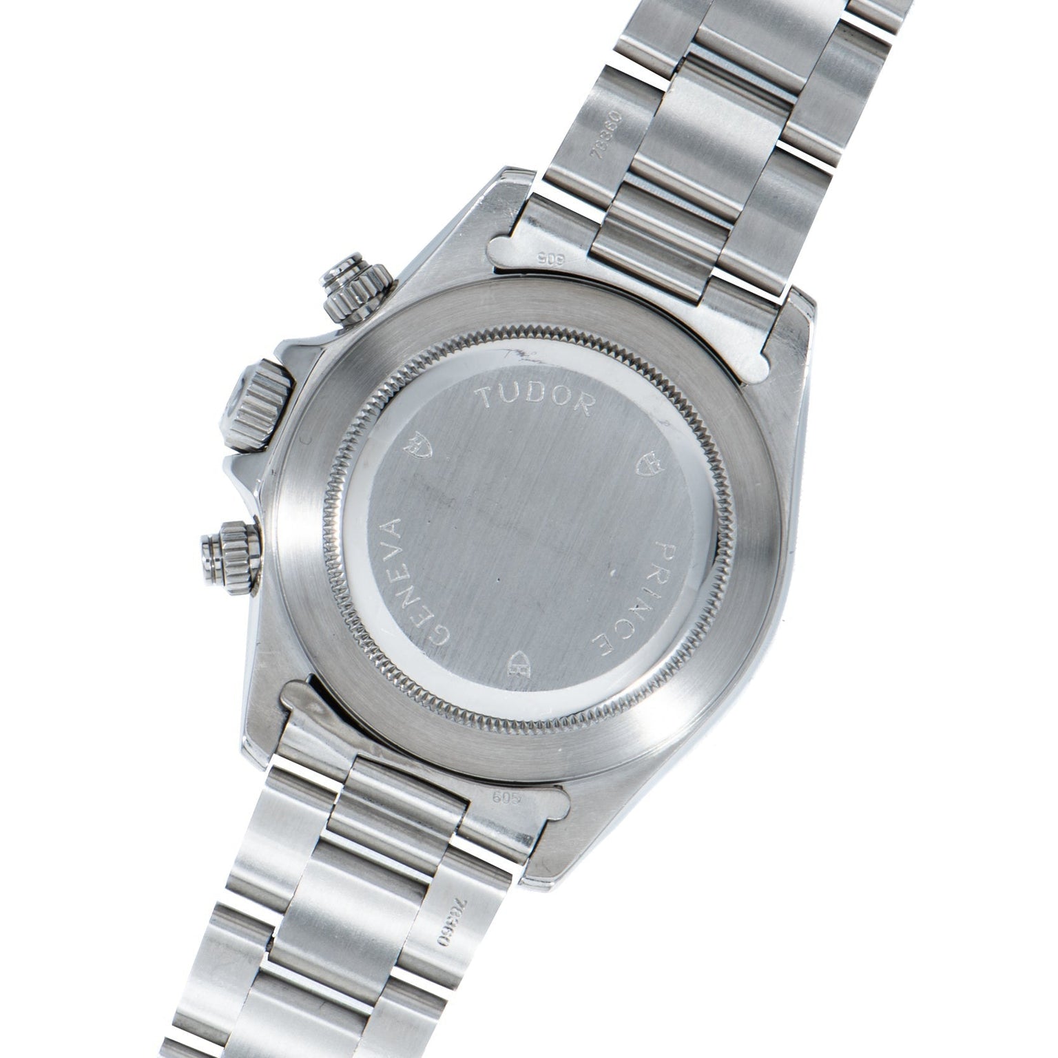 The back of a TUDOR Prince Date Chronograph Silver Albino wristwatch with an engraved stainless steel case and metal bracelet.