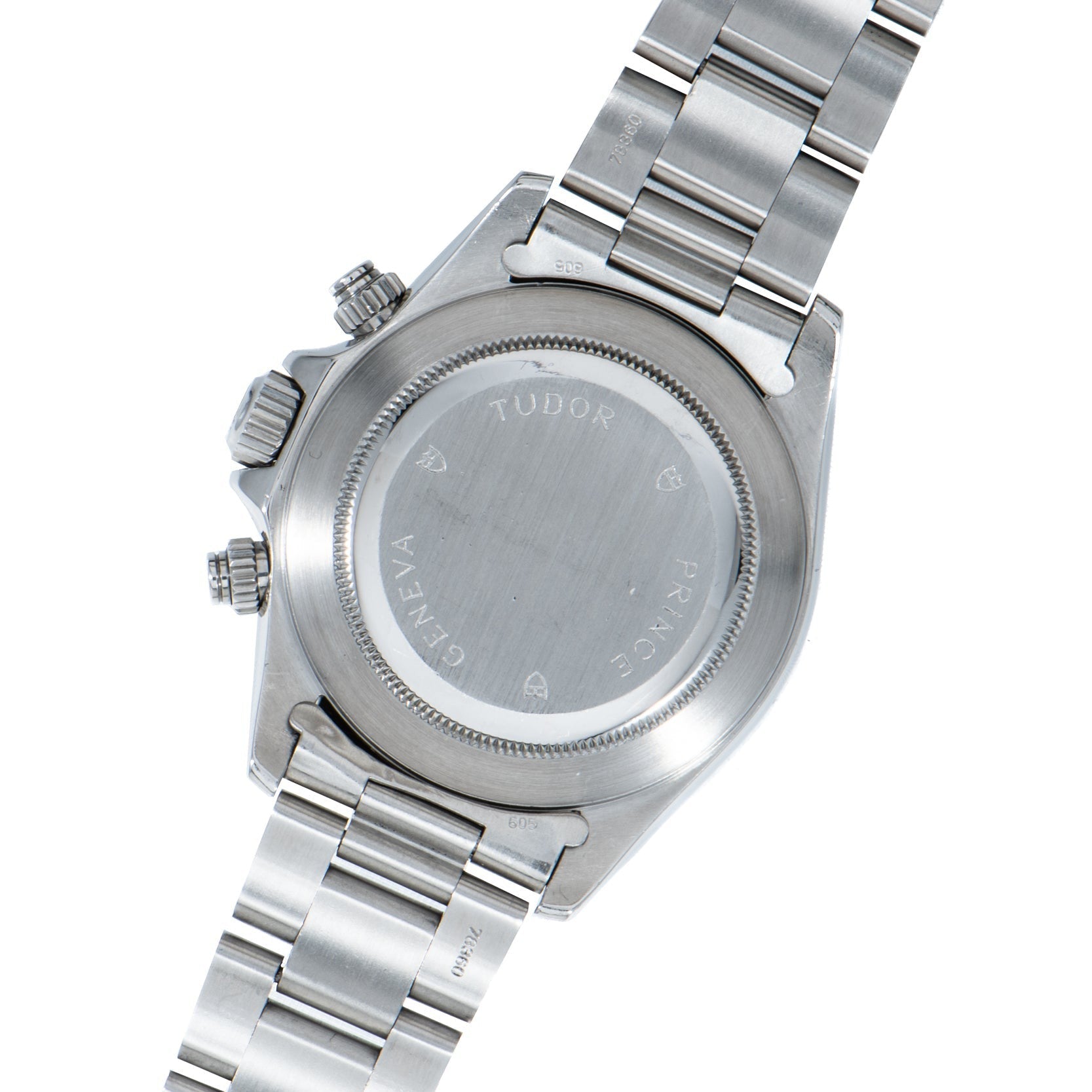 The back of a TUDOR Prince Date Chronograph Silver Albino wristwatch with an engraved stainless steel case and metal bracelet.