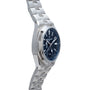 The Vacheron Constantin Overseas Dual-Time wristwatch features a blue dial and metal bracelet, displayed at an angle on a white background.