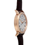 Side view of the Lange & Sohne Richard Lange gold wristwatch featuring a white face, black Roman numerals, and a brown leather strap.