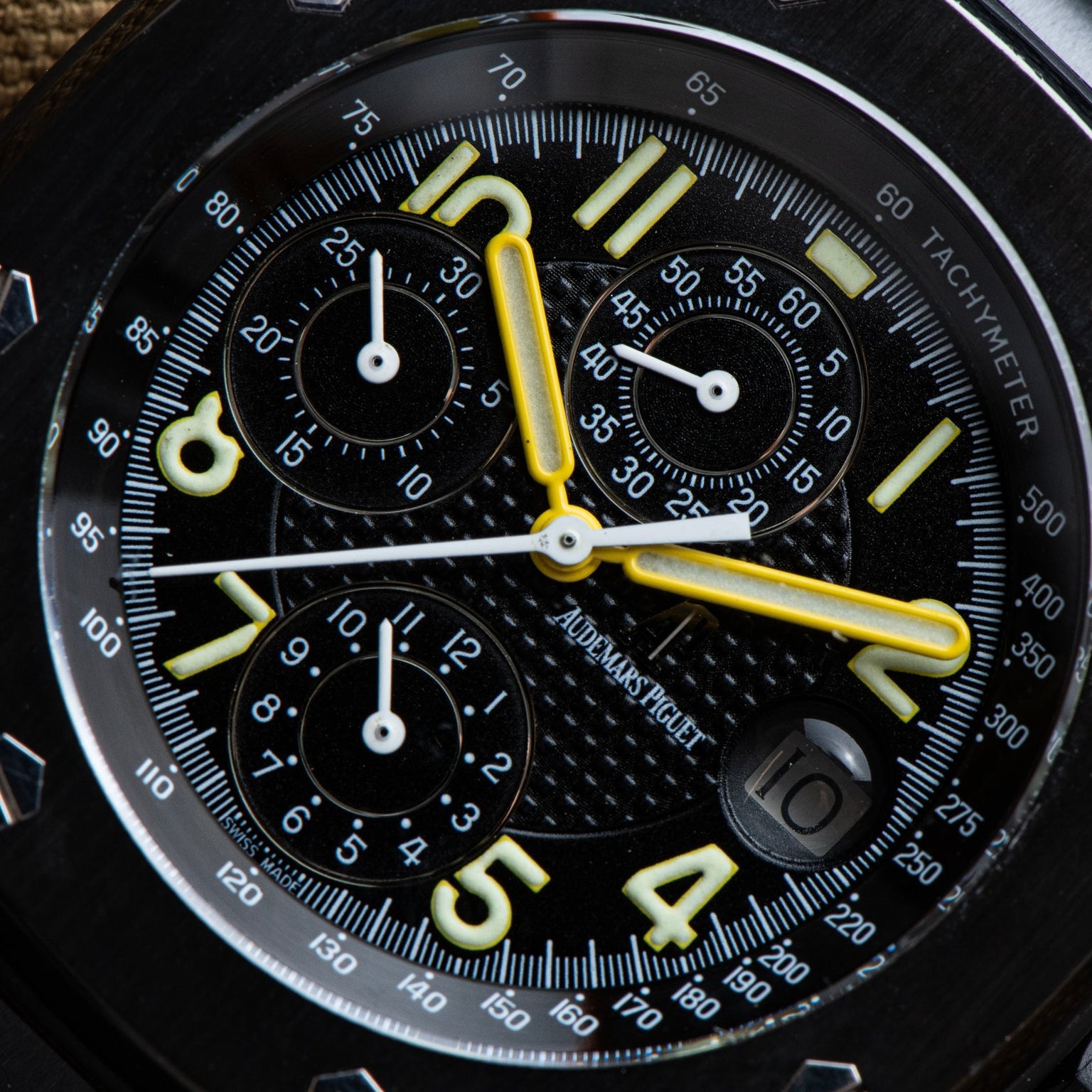 Close-up of the Audemars Piguet Royal Oak Offshore End of Days watch face, featuring yellow hands and bold white numerals on a black dial.