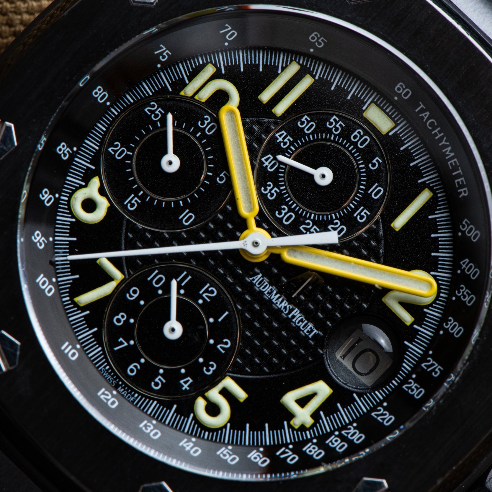 Close-up of the Audemars Piguet Royal Oak Offshore End of Days watch face, featuring yellow hands and bold white numerals on a black dial.