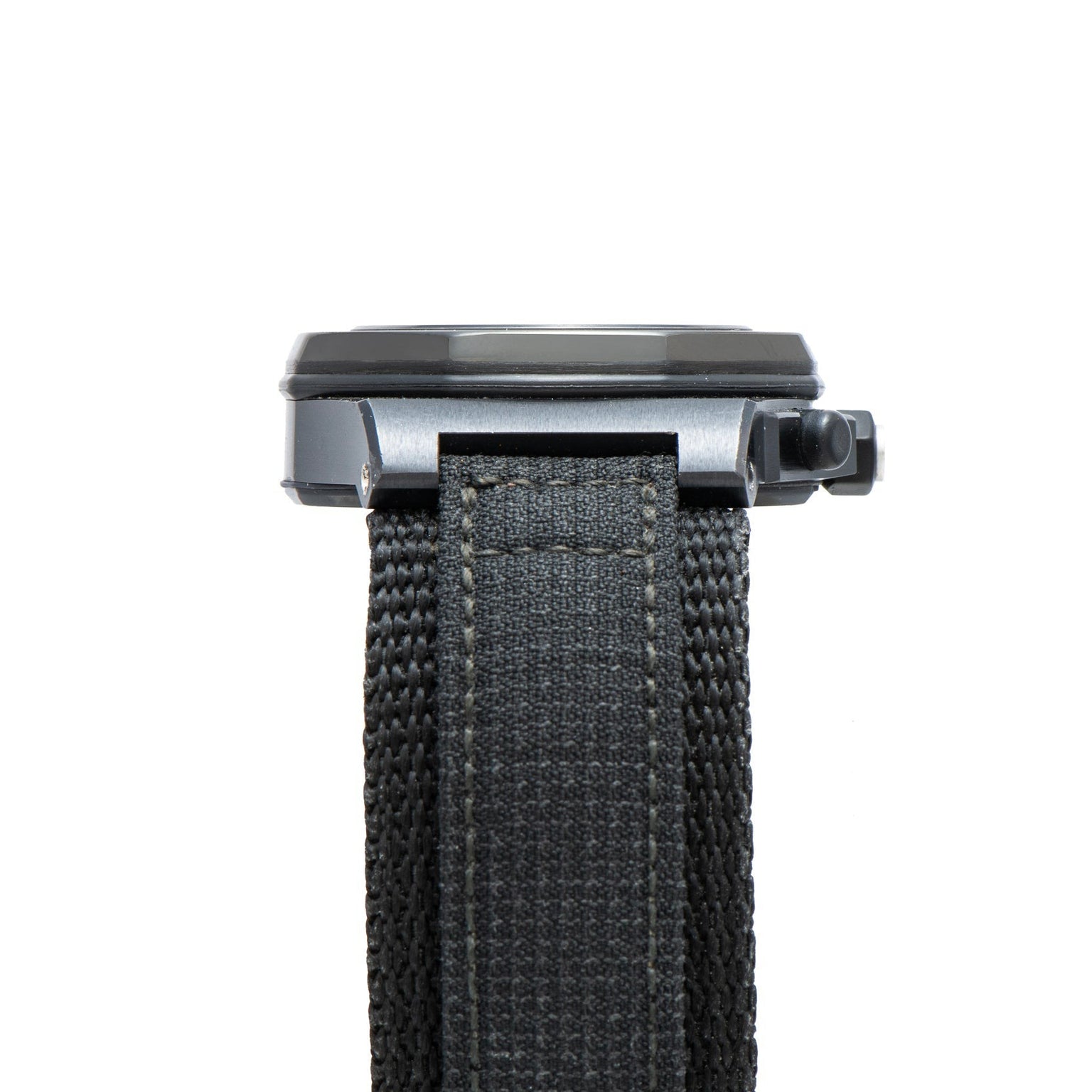 Close-up of the black strap and side view of the Audemars Piguet Royal Oak Offshore End of Days watch case with crown, isolated on a white background.
