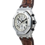 The Audemars Piguet Royal Oak Offshore Safari is a silver chronograph wristwatch with a white dial, black numerals, and a brown leather strap.