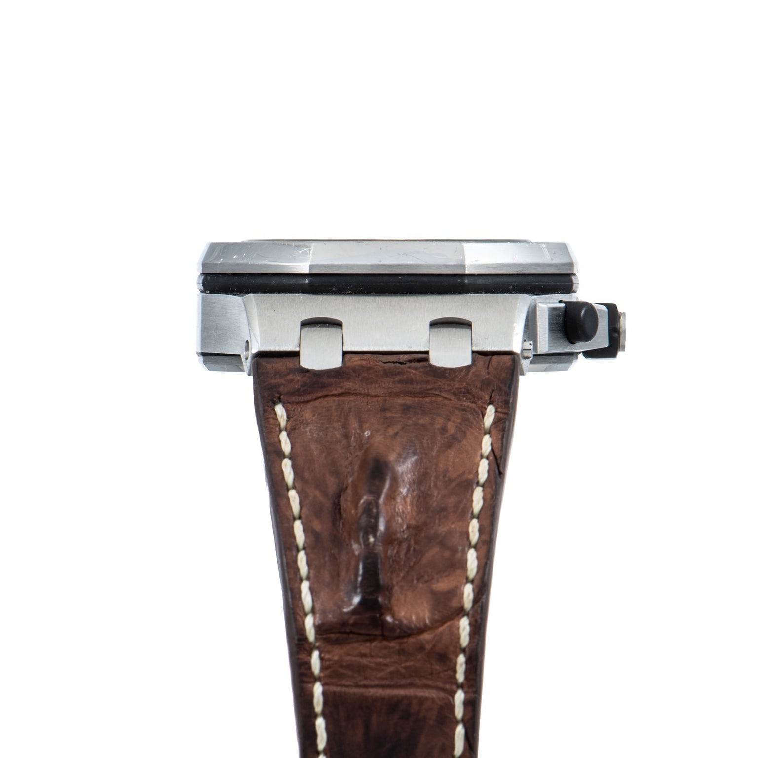 Side view of the Audemars Piguet Royal Oak Offshore Safari wristwatch featuring a brown leather strap and metal case, set against a white background.