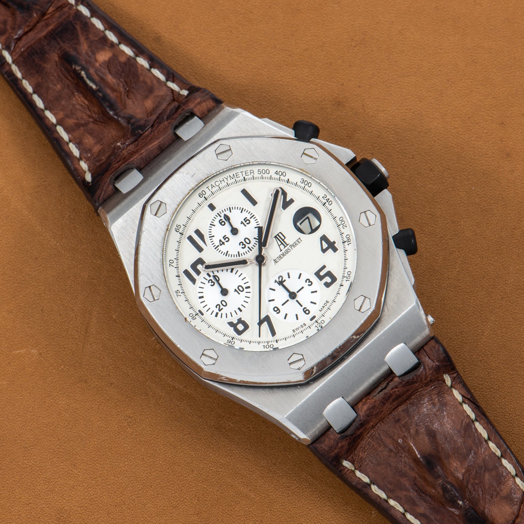 Audemars Piguet Royal Oak Offshore Safari luxury watch with a brown leather strap, white dial, three subdials, and a date window.