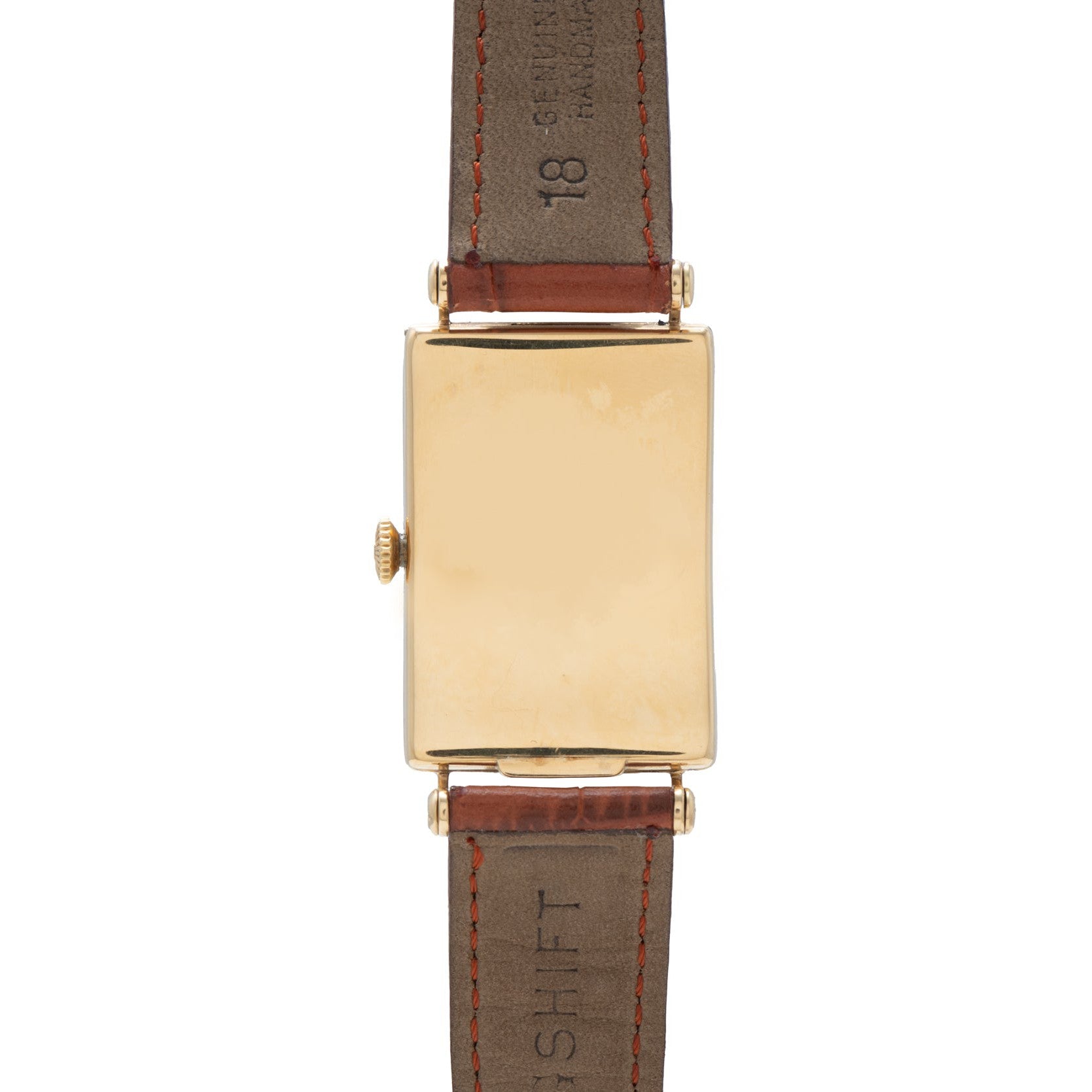 The Patek Philippe Birks Rectangular Dress Watch features a blank gold face and brown leather strap.