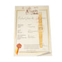 A Patek Philippe Yellow Gold Integrated Dress Watch is displayed on top of an official certificate with a red and yellow ribbon seal.