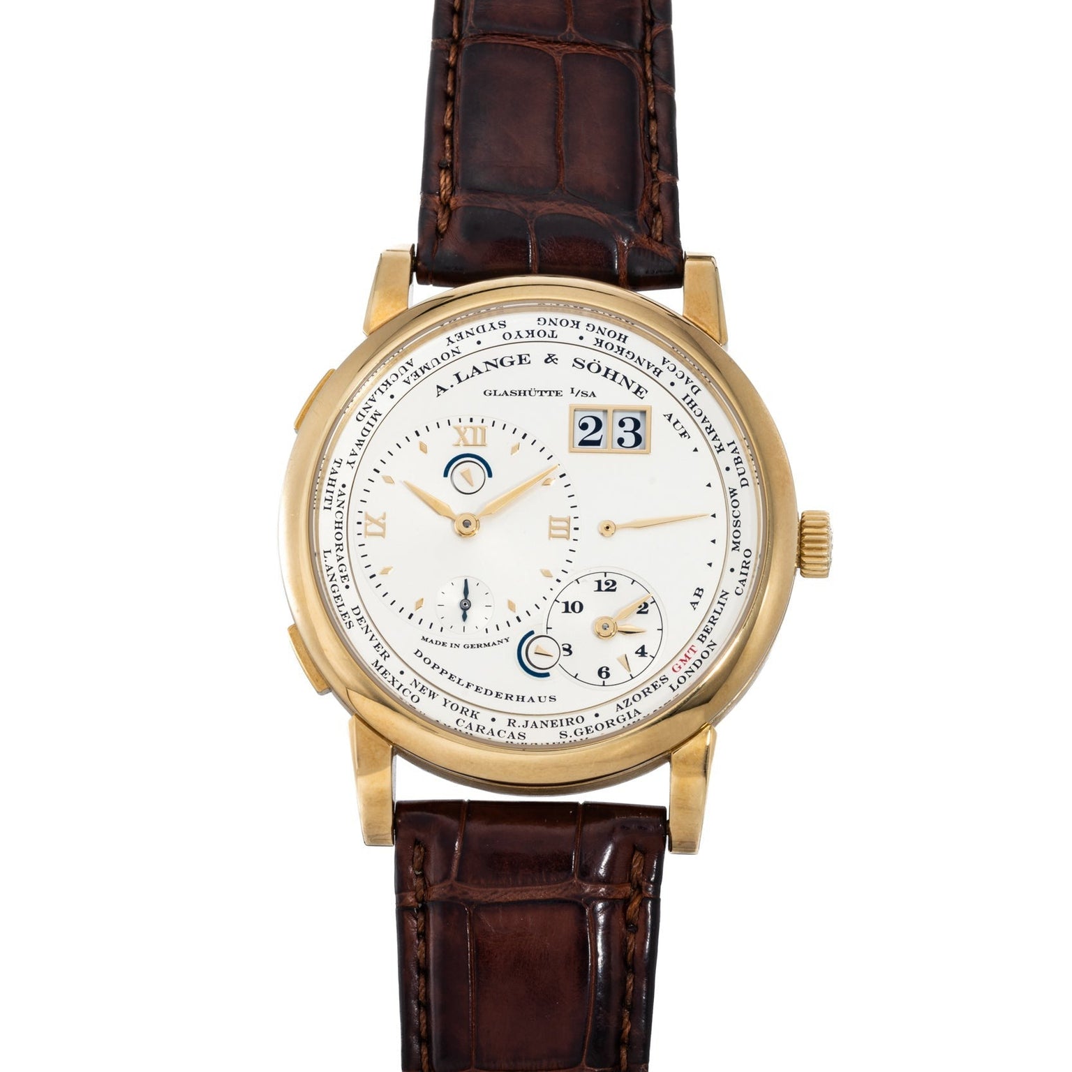 The Lange & Sohne Lange 1 Timezone features a gold case, brown leather strap, white dial with multiple subdials, and city names around the face.