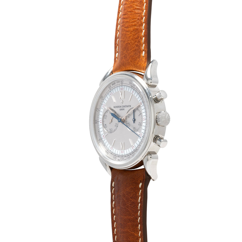The Vacheron Constantin Historiques Cornes De Vache Chronograph is shown from the side, featuring a silver case and brown leather strap against a white background.
