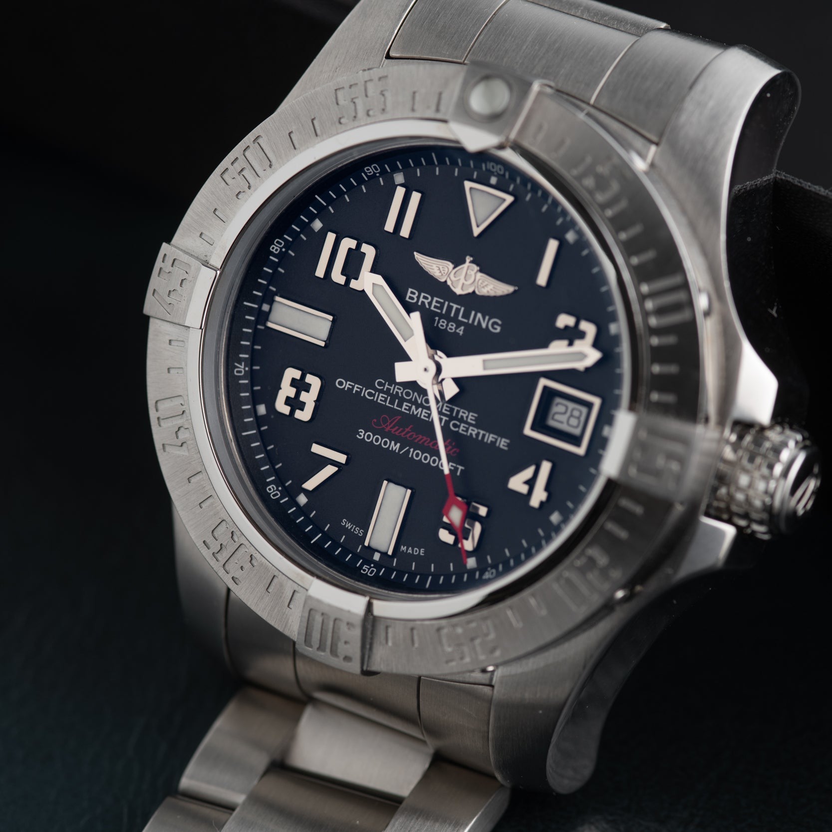 A close-up of the Breitling Avenger II Seawolf stainless steel wristwatch featuring a dark blue dial and a metal bracelet.