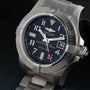 A close-up of the Breitling Avenger II Seawolf stainless steel wristwatch featuring a dark blue dial and a metal bracelet.