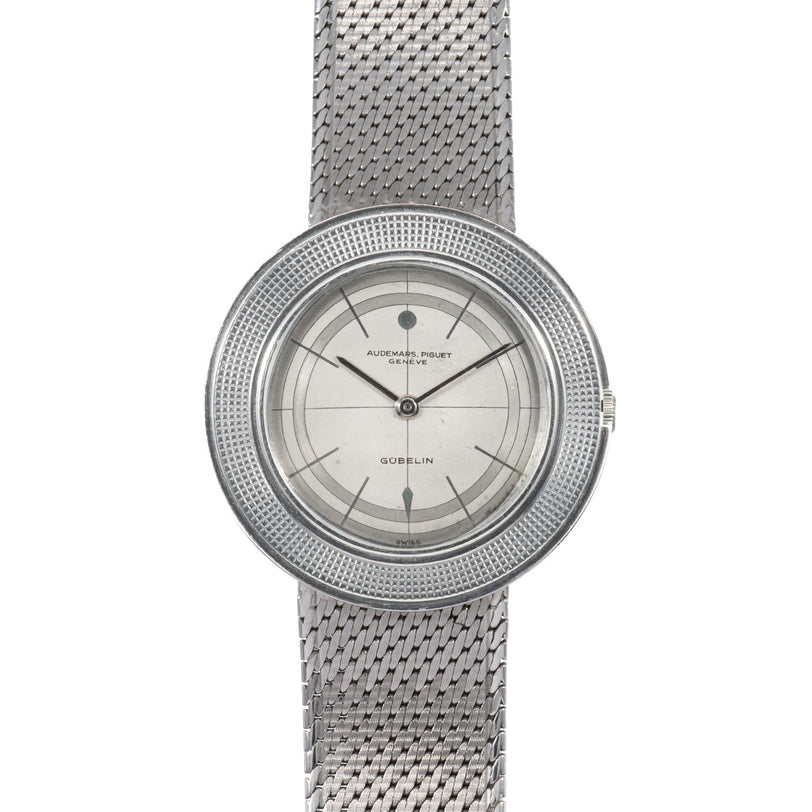 Audemars Piguet Signed Disco Volante Dress Watch Gübelin featuring a silver mesh band, round minimalist silver dial, and thin black hour markers.