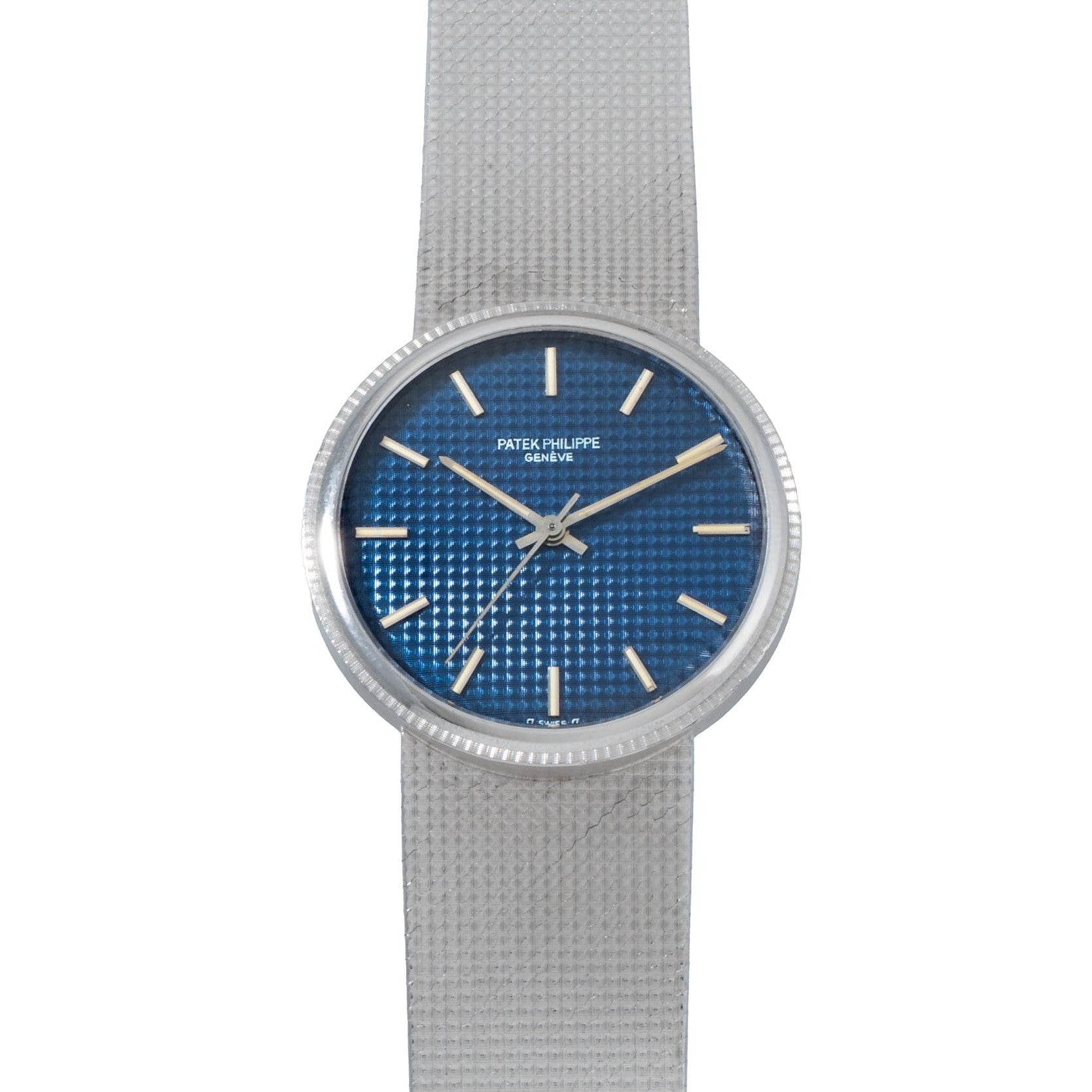 The Patek Philippe Calatrava Backwind features a textured silver band and a blue textured dial, displaying the time as 10:09.