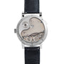 Back view of the Lange & Sohne Lange 31 mechanical wristwatch, showcasing its intricate gears and components with a black leather strap.
