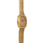 The Piaget Yellow Gold Hobnail Dress Watch features a square face, mesh band, and date window, displayed on a white background.
