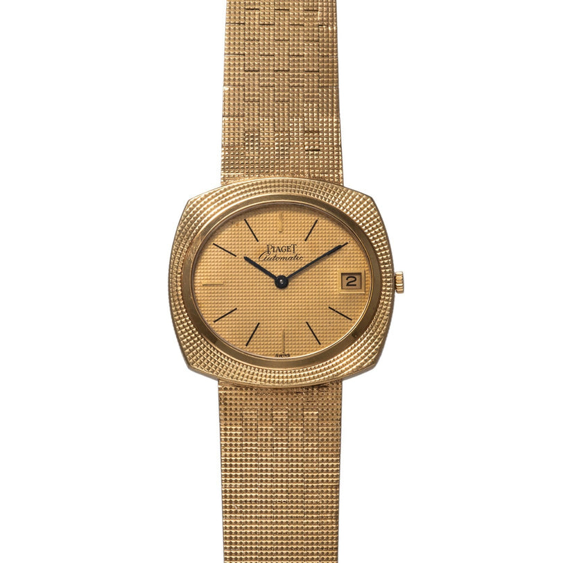 Piaget Yellow Gold Hobnail Dress Watch featuring a textured band, simple black hour markers, and a date window at 3 oclock.
