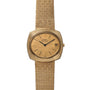 Piaget Yellow Gold Hobnail Dress Watch featuring a textured band, simple black hour markers, and a date window at 3 oclock.