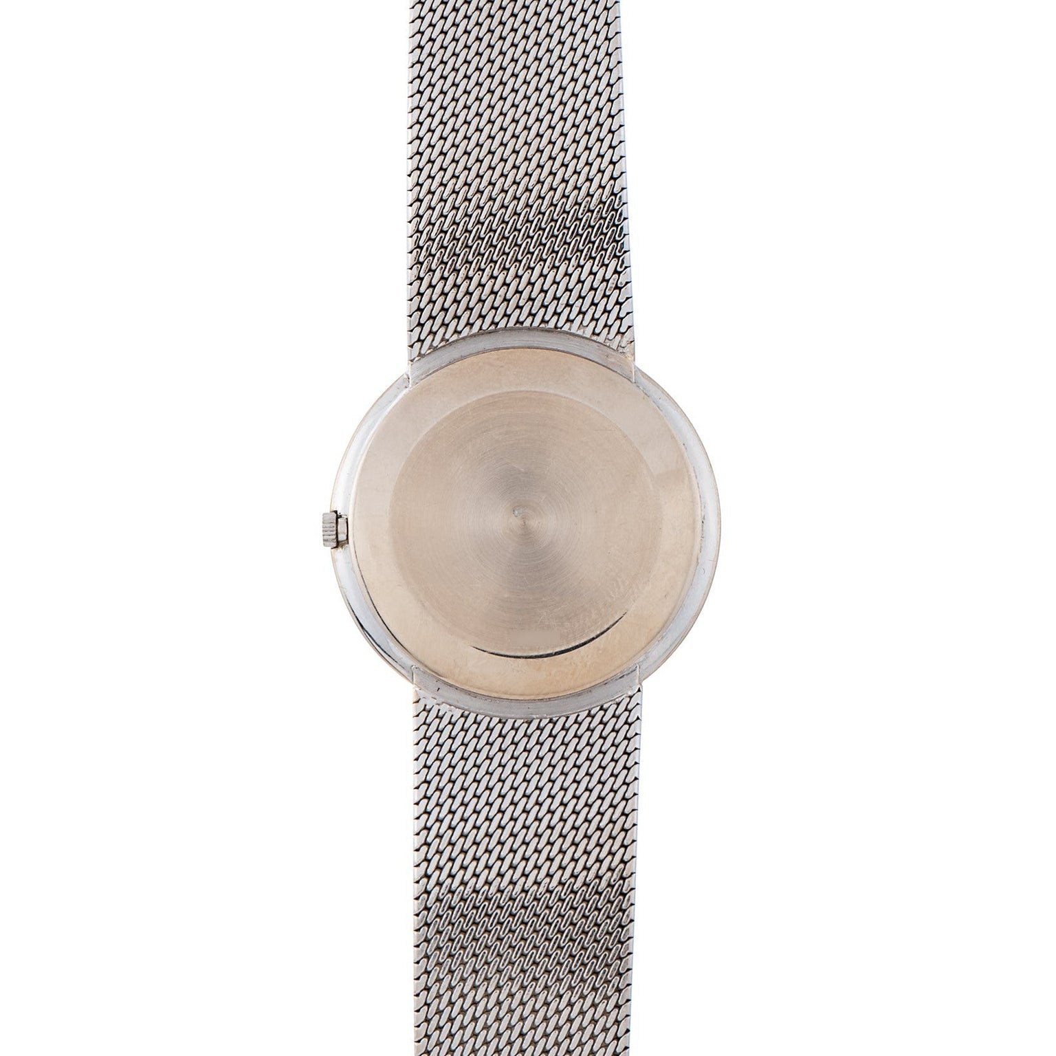 The Piaget Lapis Lazuli Dress Watch features a minimalist design with a silver mesh band and a blank, round face.