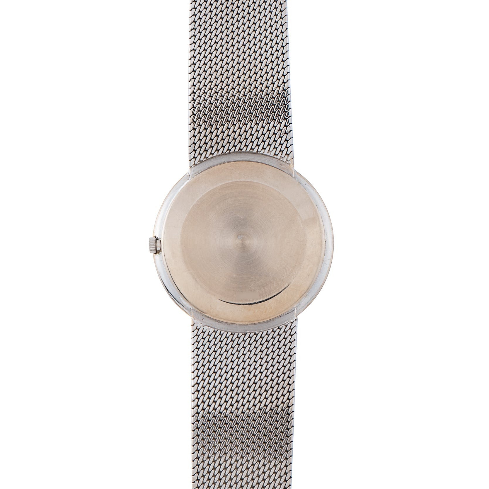 The Piaget Lapis Lazuli Dress Watch features a minimalist design with a silver mesh band and a blank, round face.