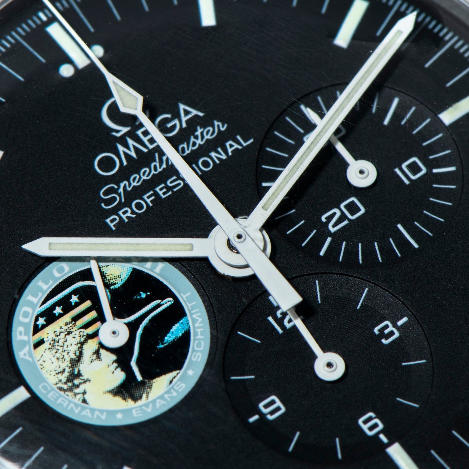 Close-up of the OMEGA Speedmaster Professional Missions Apollo XVII watch face featuring the Apollo mission emblem detail.