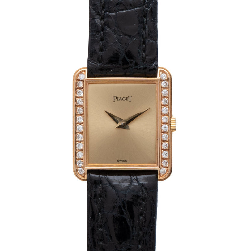 A Piaget Yellow Gold Diamond-Set Dress Watch with a rectangular face and black leather strap.