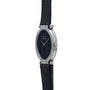 White Gold Ladies wristwatch by Piaget, featuring an oval case with a black leather strap and black dial, shown against a white background.