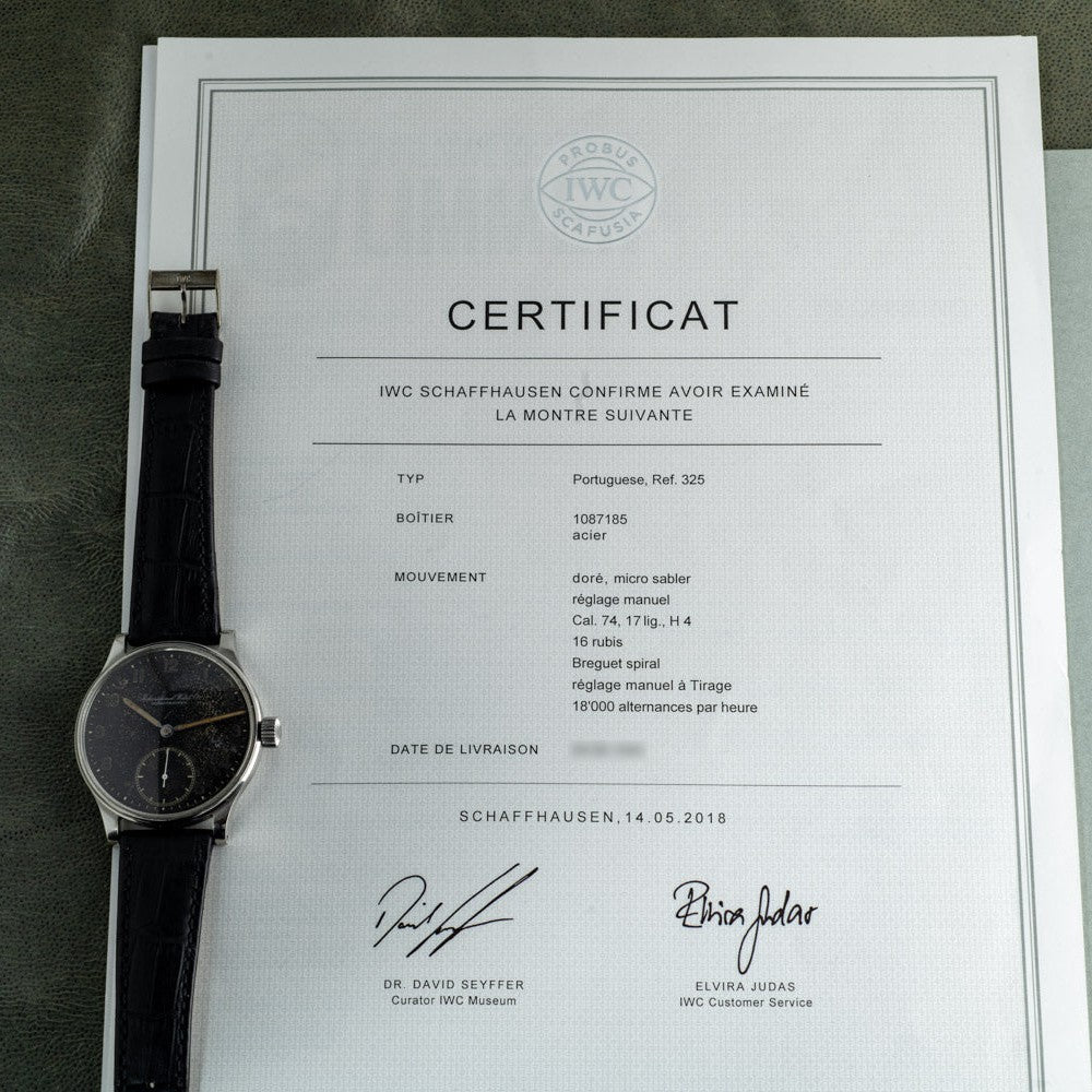An IWC Schaffhausen Portugieser wristwatch sits atop its certificate of authenticity, dated 14.05.2018.