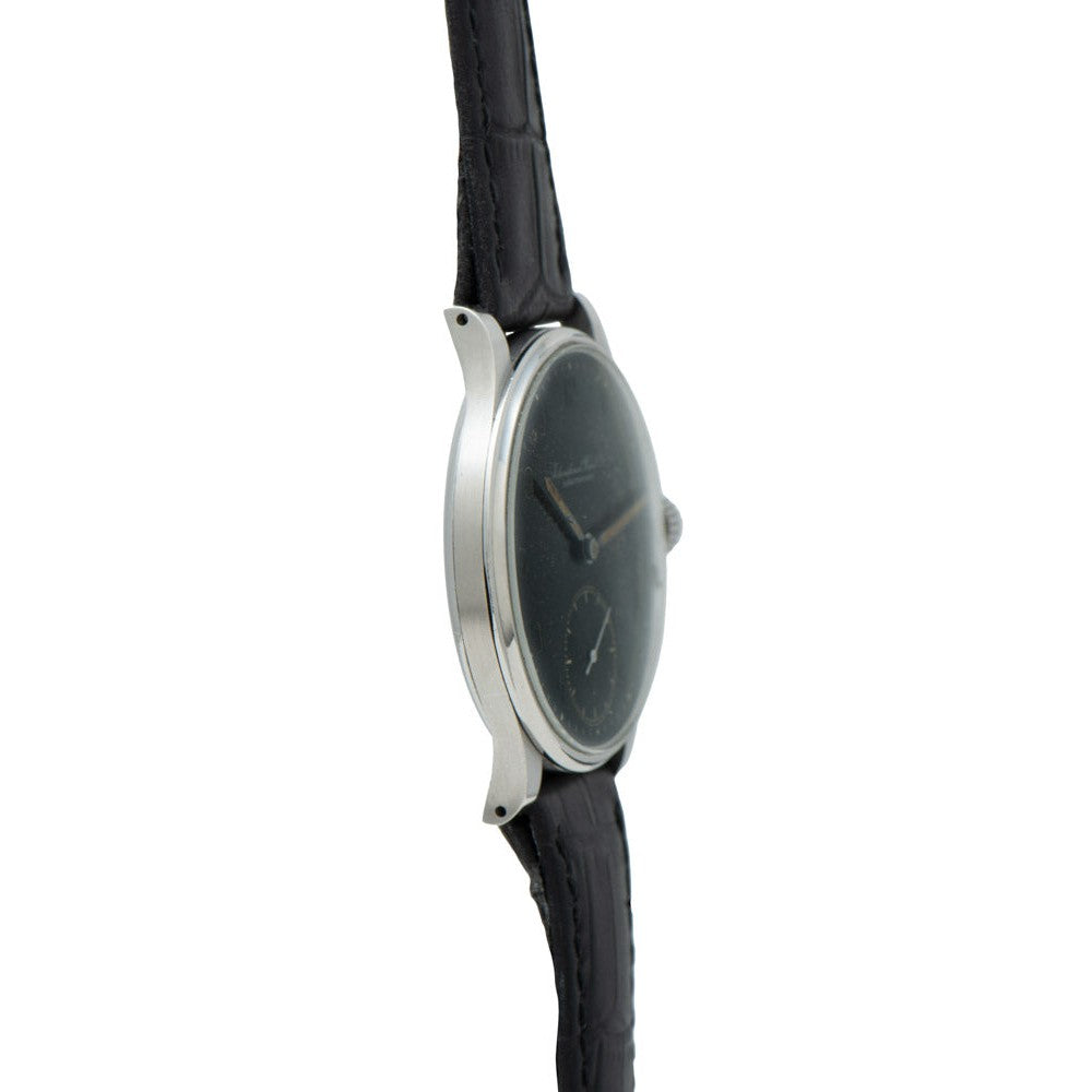 Side view of the IWC Schaffhausen Portugieser wristwatch, featuring a black leather strap and a round, dark face set against a white background.