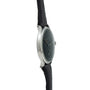 Side view of the IWC Schaffhausen Portugieser wristwatch, featuring a black leather strap and a round, dark face set against a white background.