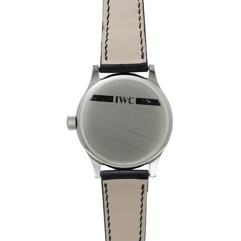 The back of the IWC Schaffhausen Portugieser wristwatch, engraved with IWC, features a beige leather strap with black stitching.