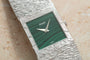 White gold Piaget Malachite dress watch with a textured band and a green, patterned square face, displaying the time as 10:08.