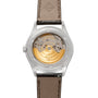 Close-up of the Patek Philippe Annual Calendar Moonphase’s transparent back, revealing its gold automatic movement and brown leather strap.