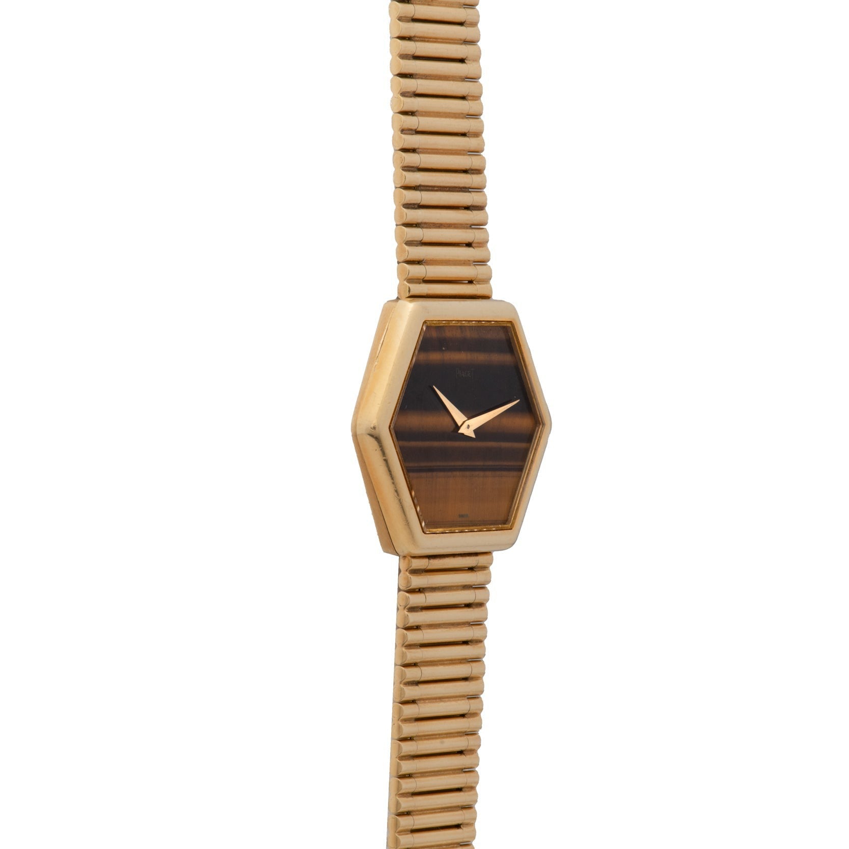 Piaget Hexagonal Tigers Eye gold watch features a brown hexagonal face and a segmented gold band, displayed on a white background.