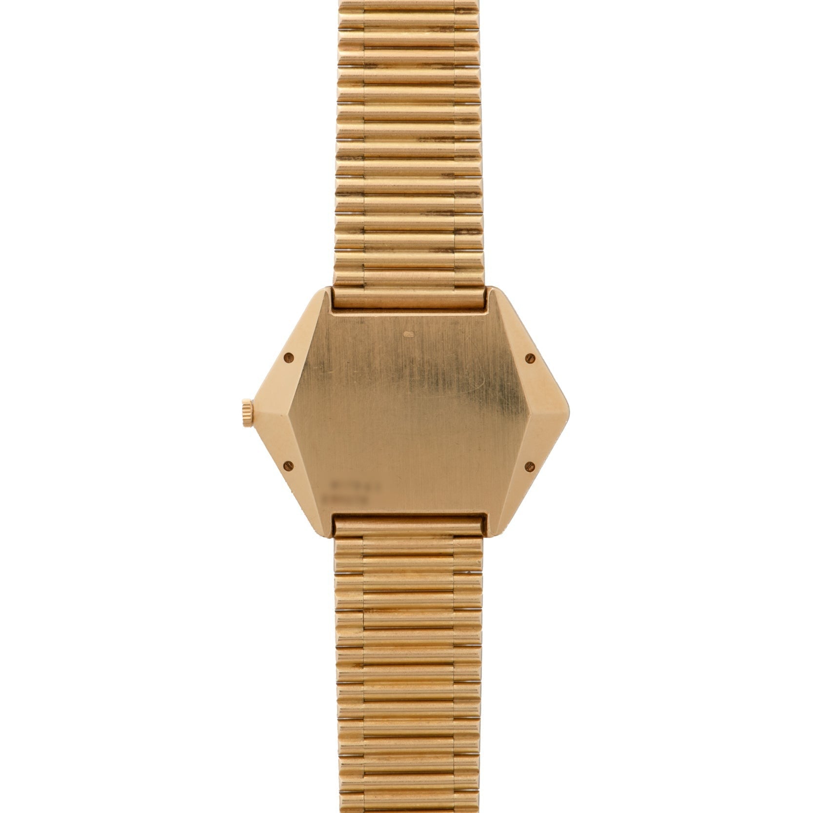 Piagets Hexagonal Tigers Eye gold wristwatch features a geometric hexagonal face and a ribbed metal band, shown from the back.