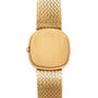 The Patek Philippe Ellipse TV Case is a gold wristwatch featuring a blank square face and a woven metal band.