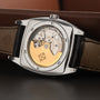 Close-up of the Patek Philippe Gondolo Annual Calendars exposed mechanical movement with a gold rotor and black leather strap.