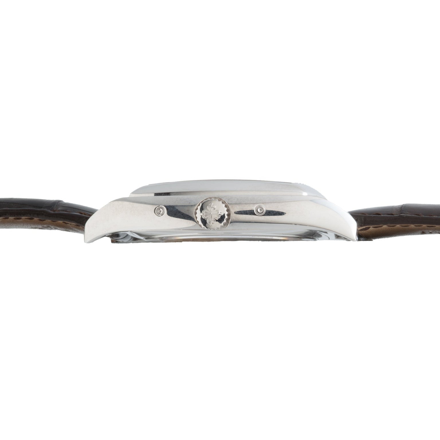 Side view of the Patek Philippe Gondolo Annual Calendar’s silver case with crown, attached to a brown leather strap.
